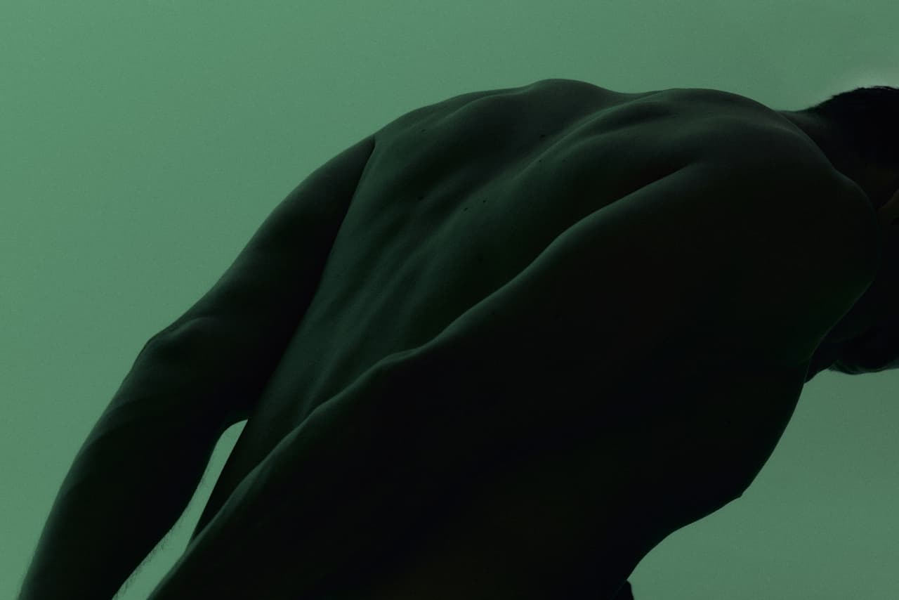 Man's back and shoulders, editorial health photography