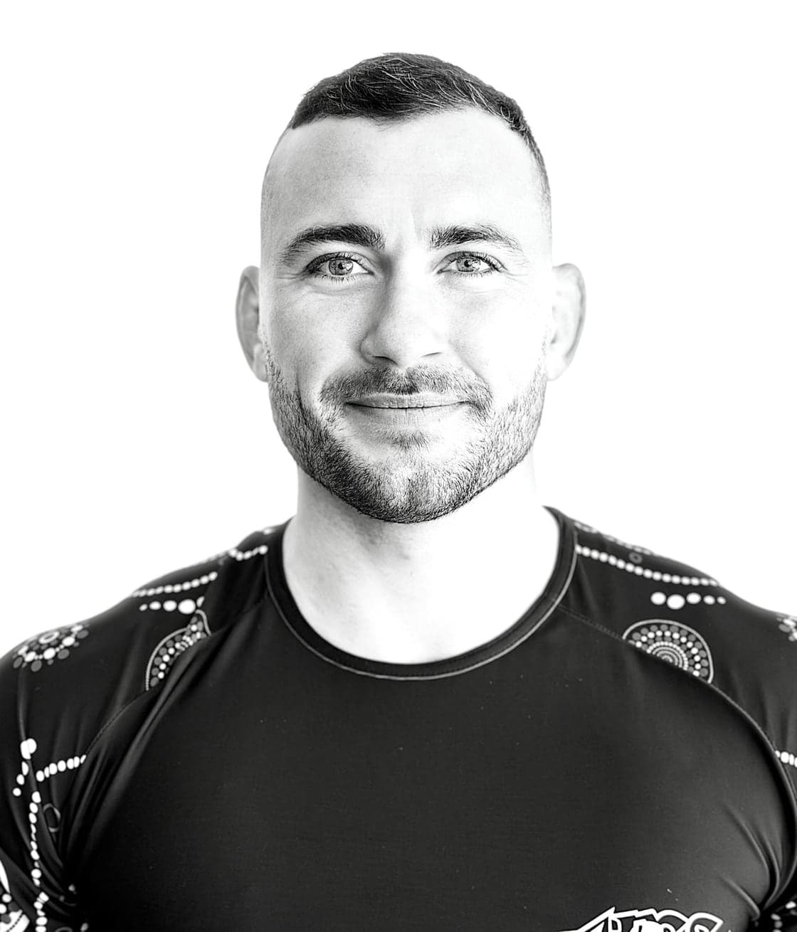 Kyle Chapman in a rash guard, looking to camera.